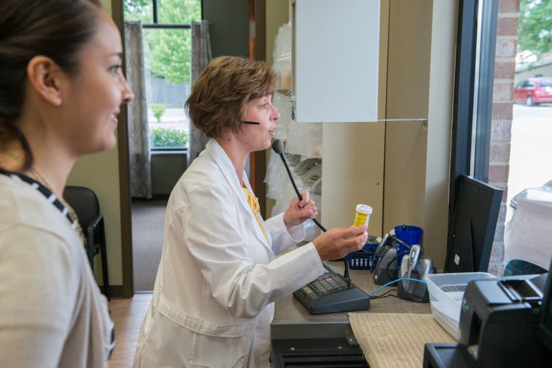 Smiling patient using the pharmacy drive-up window